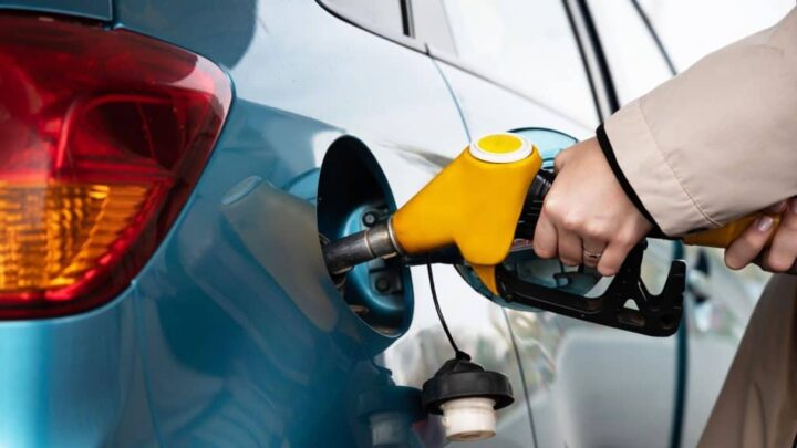 frentista abastecendo um carro com gasolina pela bomba de combustível